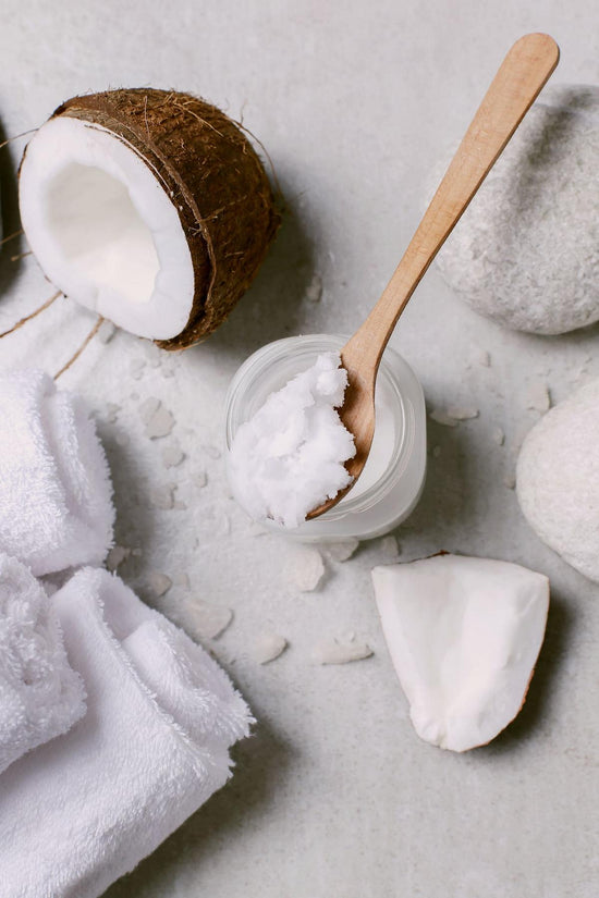 Coconut Oil on a spoon - Coconut Oil is an ingredient in BeSilken Body Balm Stick